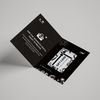 Black gift card with white text and graphics on a gray background