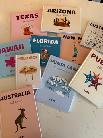 Collection of travel-themed books on a textured surface