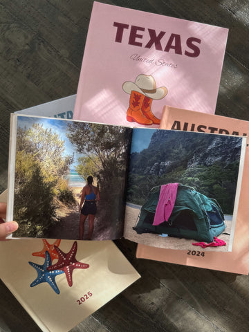 stack of photobooks with open pages on top.
