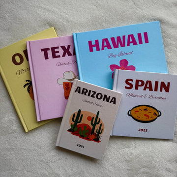 five photobooks on top of each other