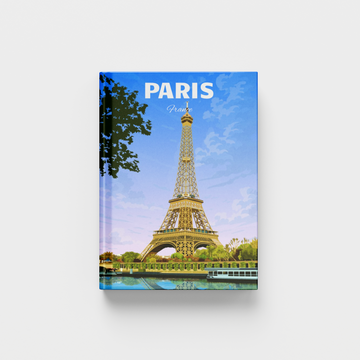 A hardcover travel photobook featuring a cover print of the Eiffel Tower in Paris under a blue sky, with the word 'PARIS' printed at the top, shown on a light gray background.