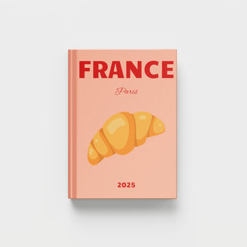 photobook with 'France Paris 2025' on a peach cover featuring a croissant illustration.