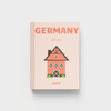 photobook for Germany with a house illustration on a light pink background