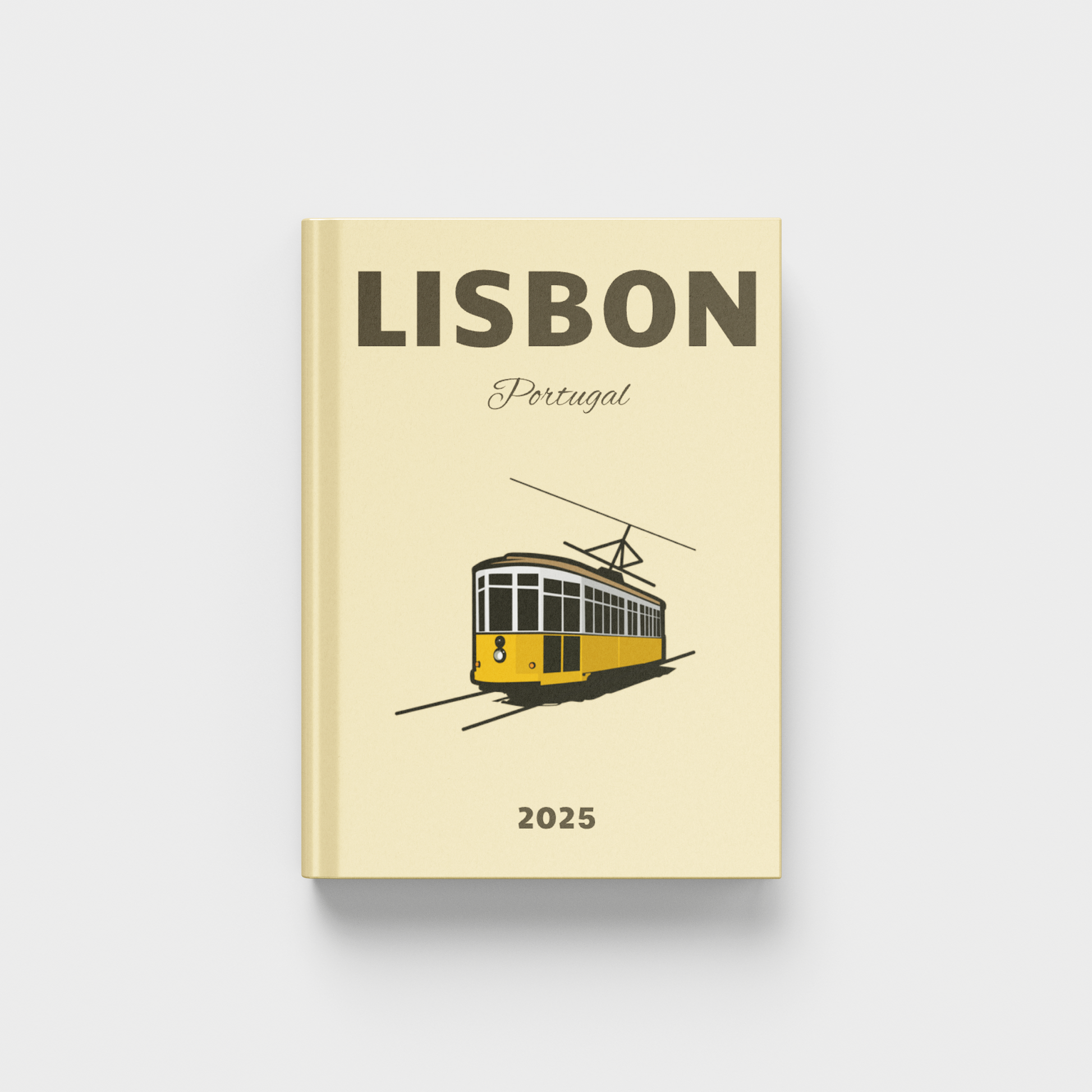 Beige photobook cover with a tram illustration and 'Lisbon Portugal' text on a white background