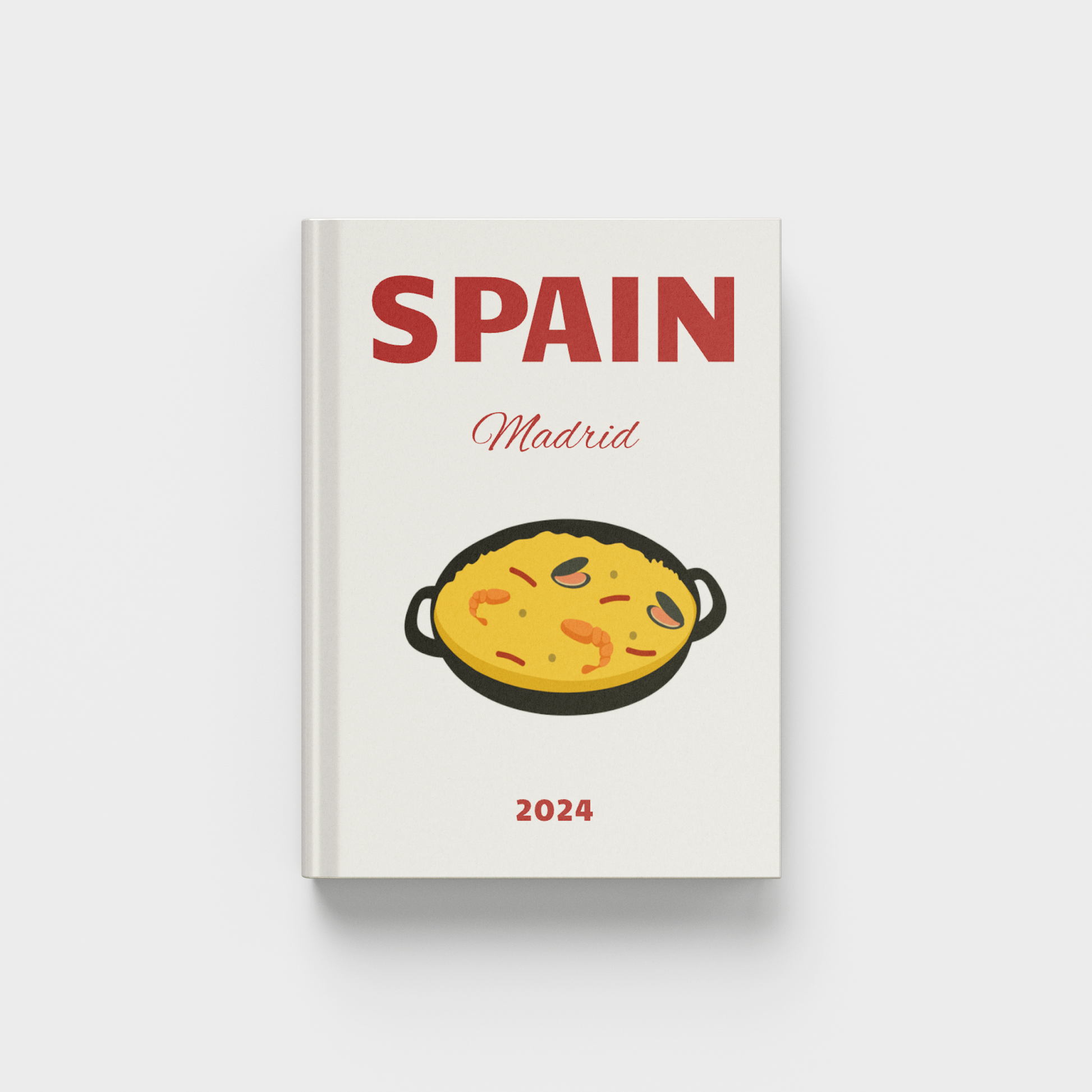 photobook cover with 'Spain Madrid 2024' text and a pan of food illustration on a white background