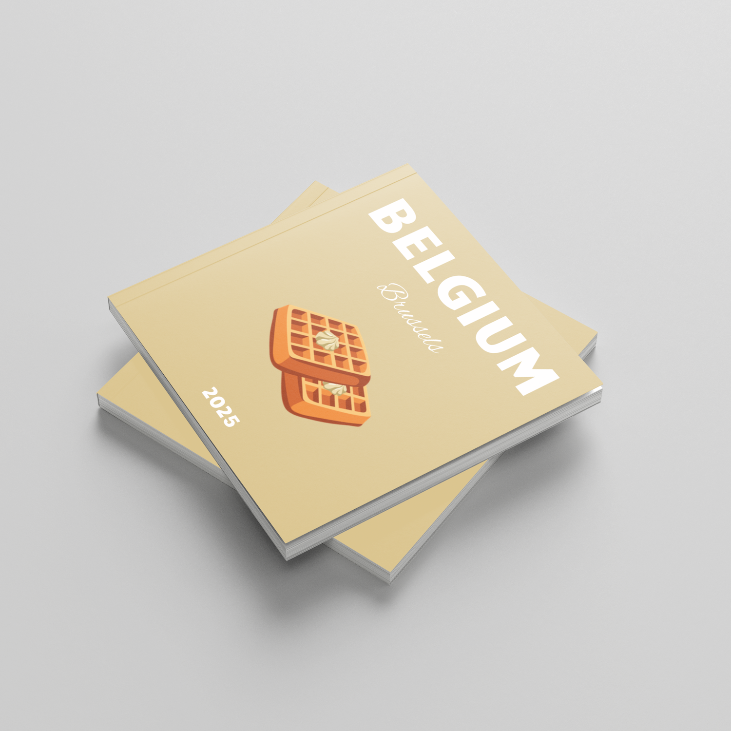 Two photobooks titled 'Belgium' with a waffle illustration on a light gray background