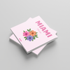 square photobook with floral design and 'MIAMI' text on a gray background