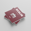 Red square photobook titled 'Berlin' with architectural design on a light gray background