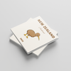 Two white square photobooks with a kiwi bird illustration and 'New Zealand 2025' text on a light gray background
