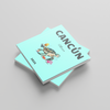 Two turquoise photobooks with 'Cancún' and a turtle illustration on a gray background