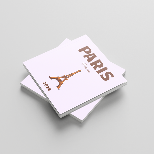 Stack of light purple square photobooks with 'Paris' and Eiffel Tower design on a light gray background