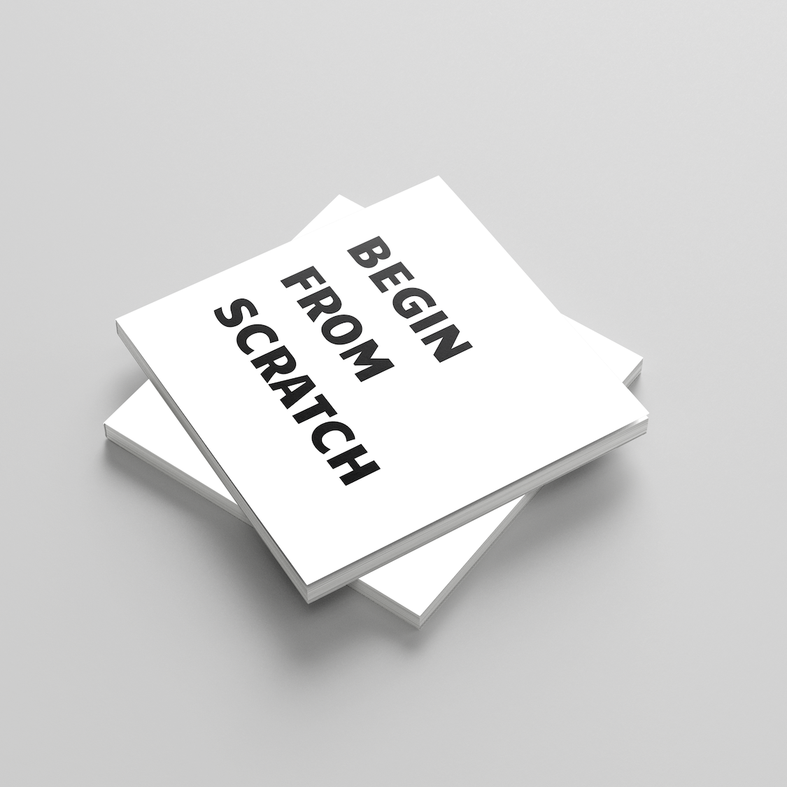 Stack of white books with 'Begin from Scratch' text on a gray background