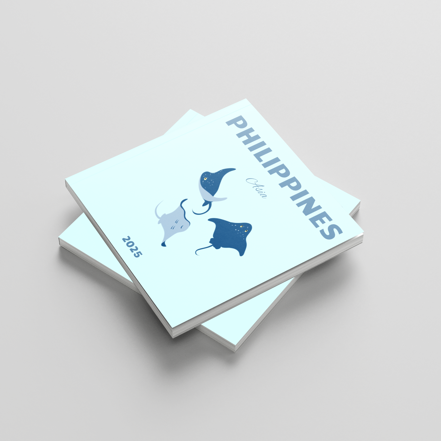 Two square photobooks with illustrations of stingrays, titled 'Philippines', on a light gray background.