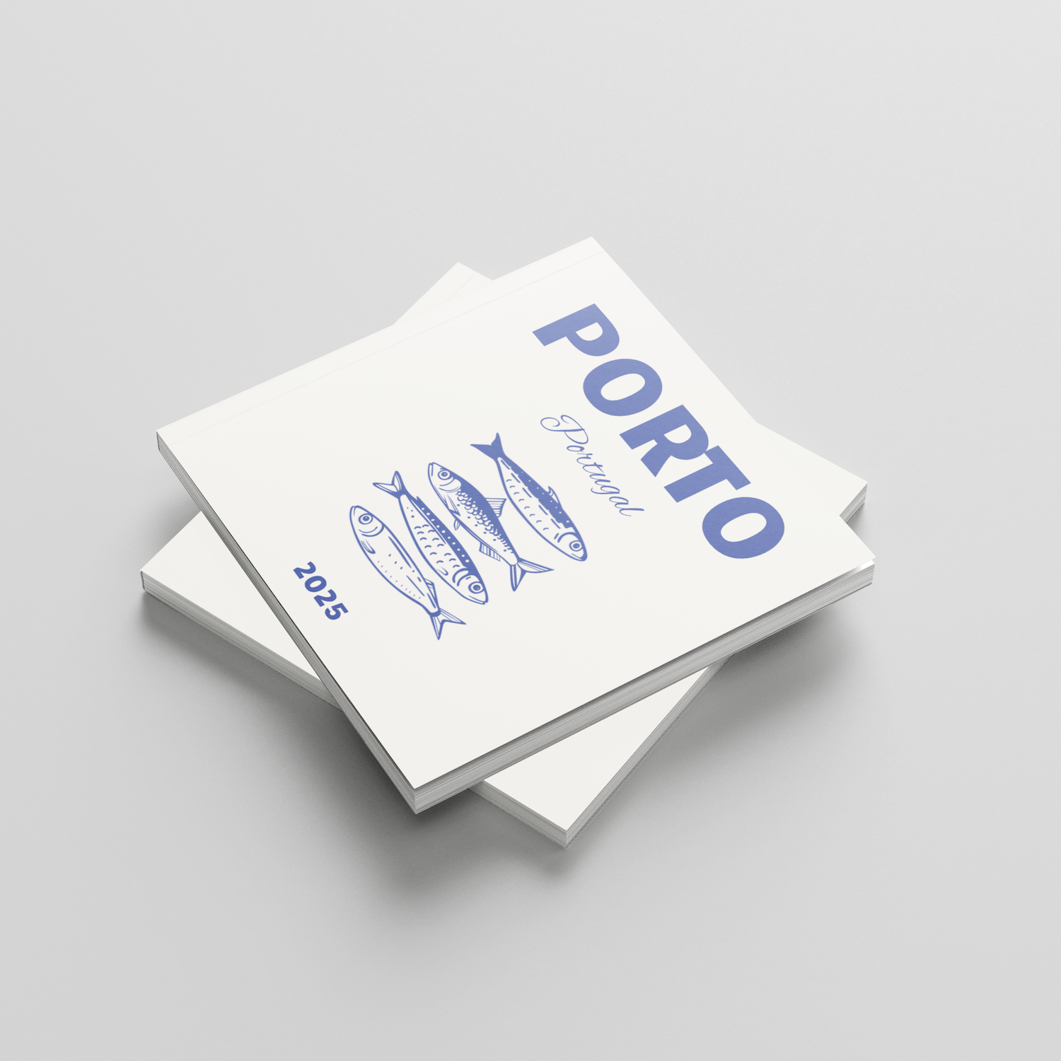 Two white square photobooks with blue text titled 'Porto' and fish illustrations on a light gray background