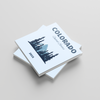 Stack of photobooks titled 'Colorado' on a light gray background