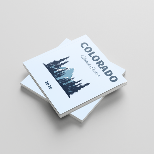 Stack of photobooks titled 'Colorado' on a light gray background