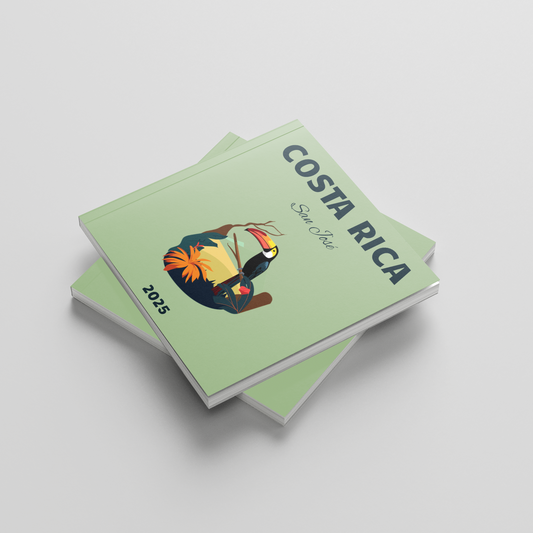 Stack of green photobooks with a toucan illustration and 'Costa Rica' text on a light gray background