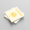 Stack of square photobooks with 'Florida' design on a gray background