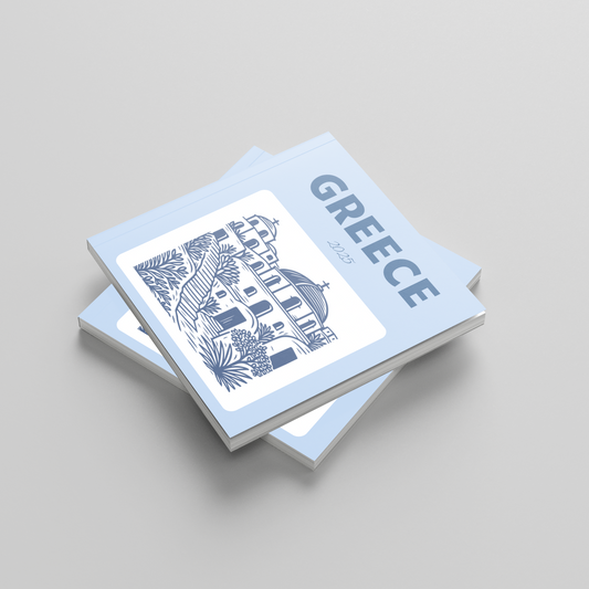 Stack of photobooks with 'Greece' and architectural illustration on a light gray background