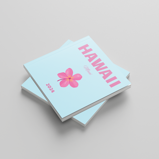 Two light blue square photobooks with a pink flower design and 'Hawaii' text on a gray background