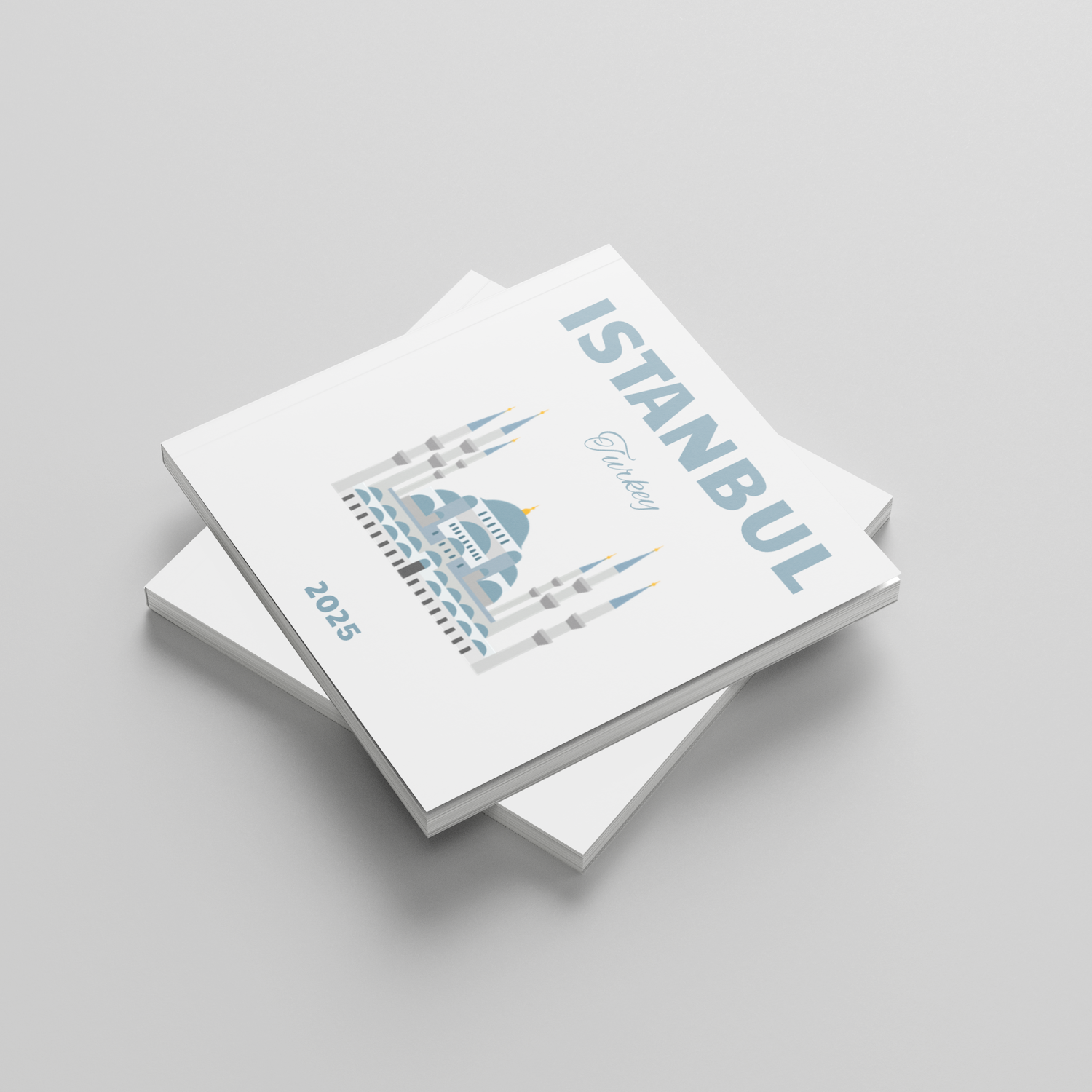 Stack of square photobooks with 'Istanbul' and '2025' on a gray background