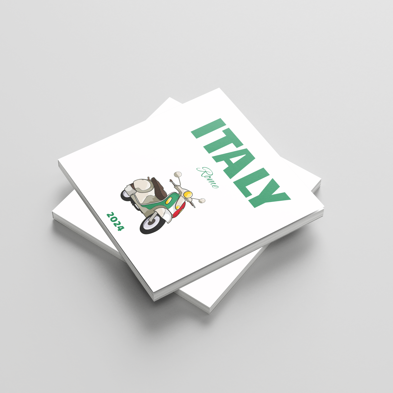 Stack of square photobooks with 'ITALY' and a vespa design on the cover against a light gray background