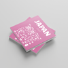 Two pink books with Japanese text and 'JAPAN' printed on a gray background
