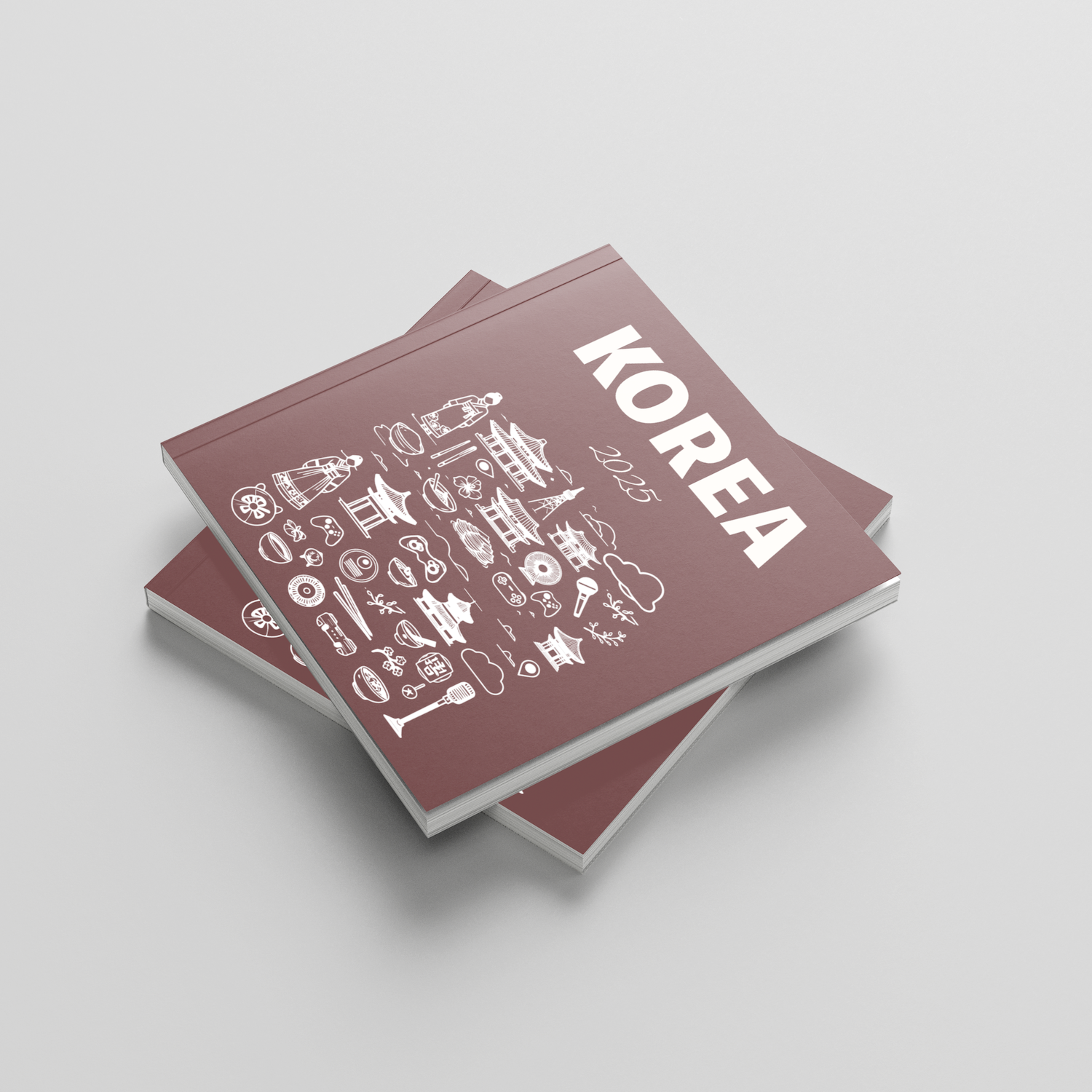 Stack of photobooks titled 'Korea' on a light gray background