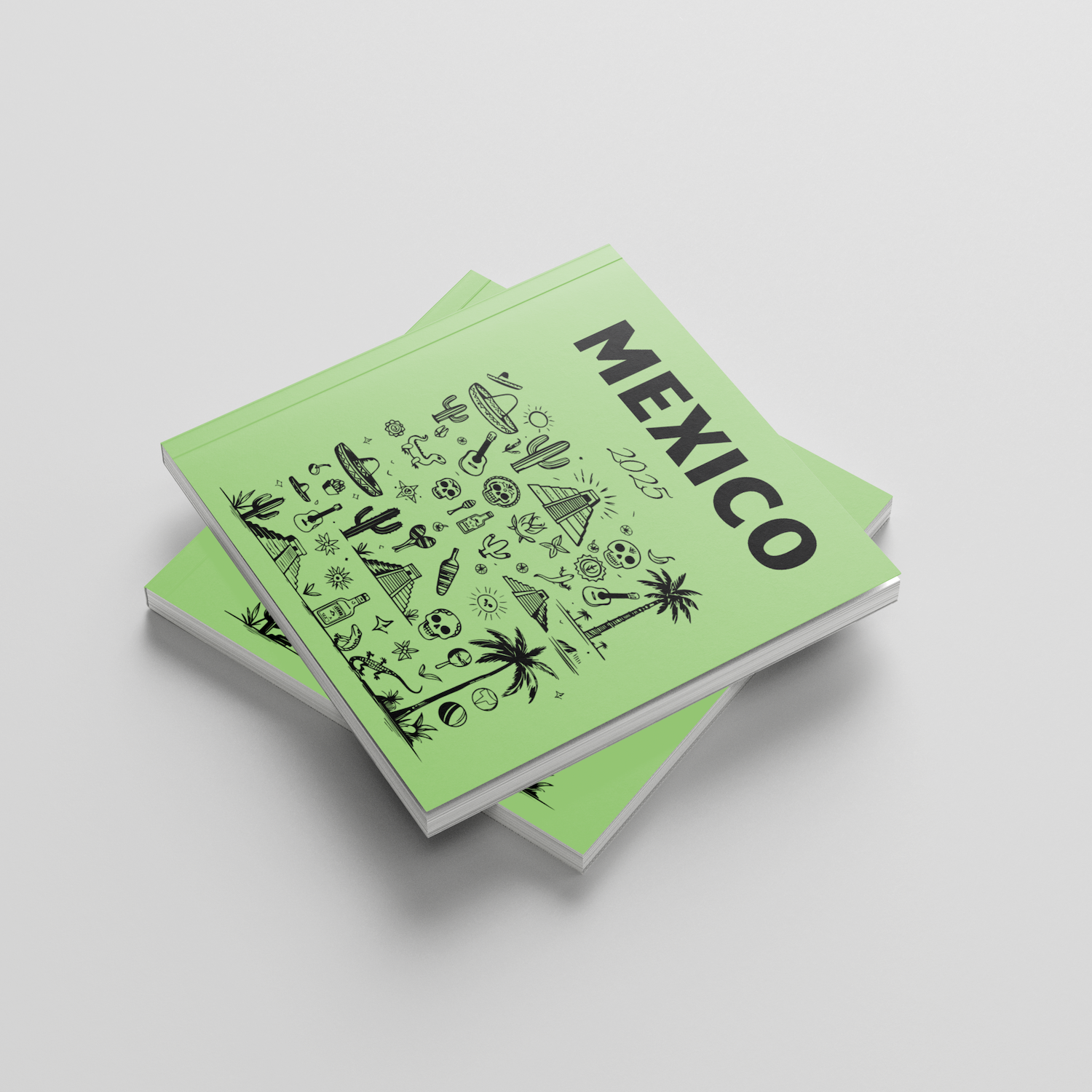 Two green photobooks with 'Mexico' on the cover on a light gray background