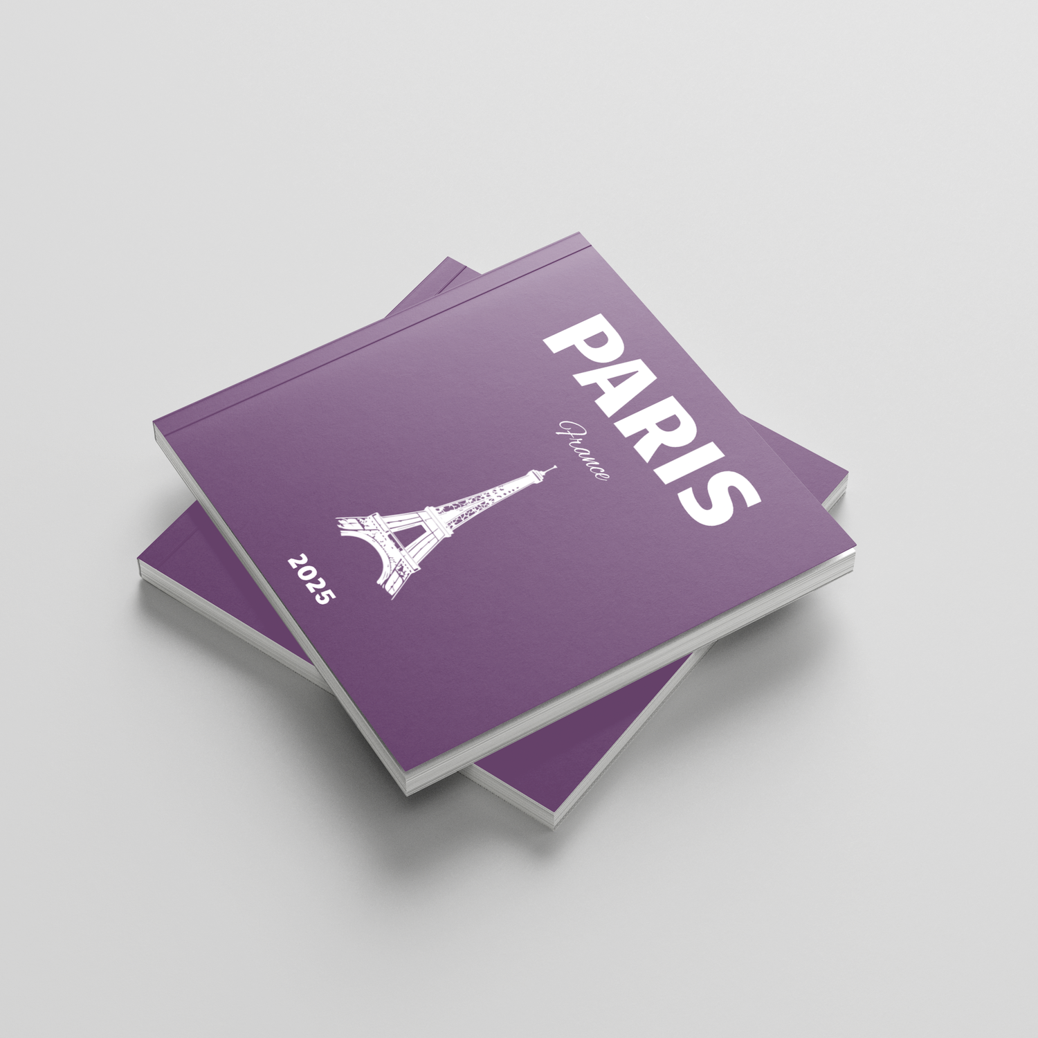 Purple books with 'Paris' and Eiffel Tower design on a light gray background