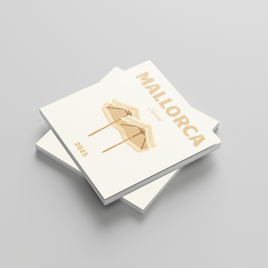 Two white square photobooks with gold text of 'Mallorca' and design on a gray background