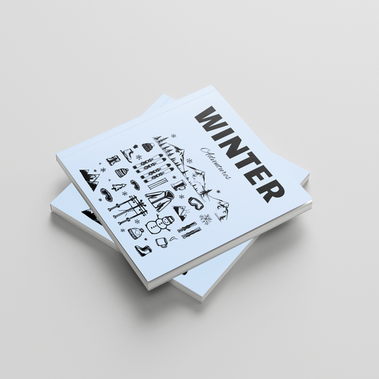 Stack of photobooks titled 'Winter' on a light gray background