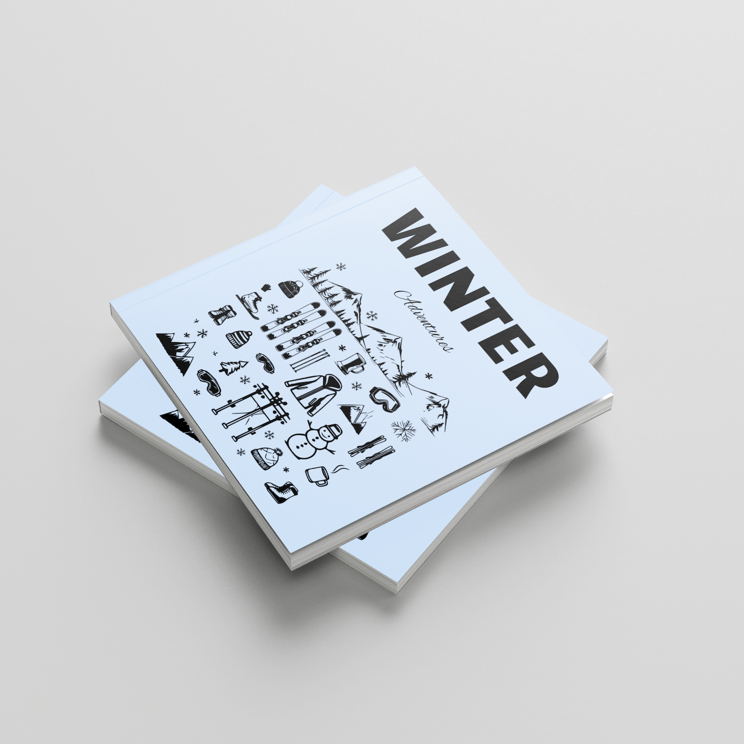 Stack of photobooks titled 'Winter' on a light gray background