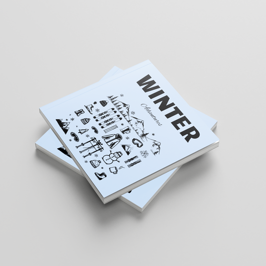 Stack of photobooks titled 'Winter' on a light gray background