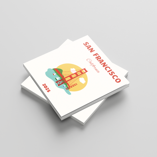 Stack of white square photobooks with colorful San Francisco design on a gray background