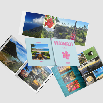 Collection of travel photo books with 'Hawaii' theme on a light gray background